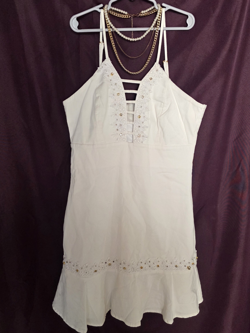 Nine Pockets brand white mini dress with gold beaded trim and lace-up detail